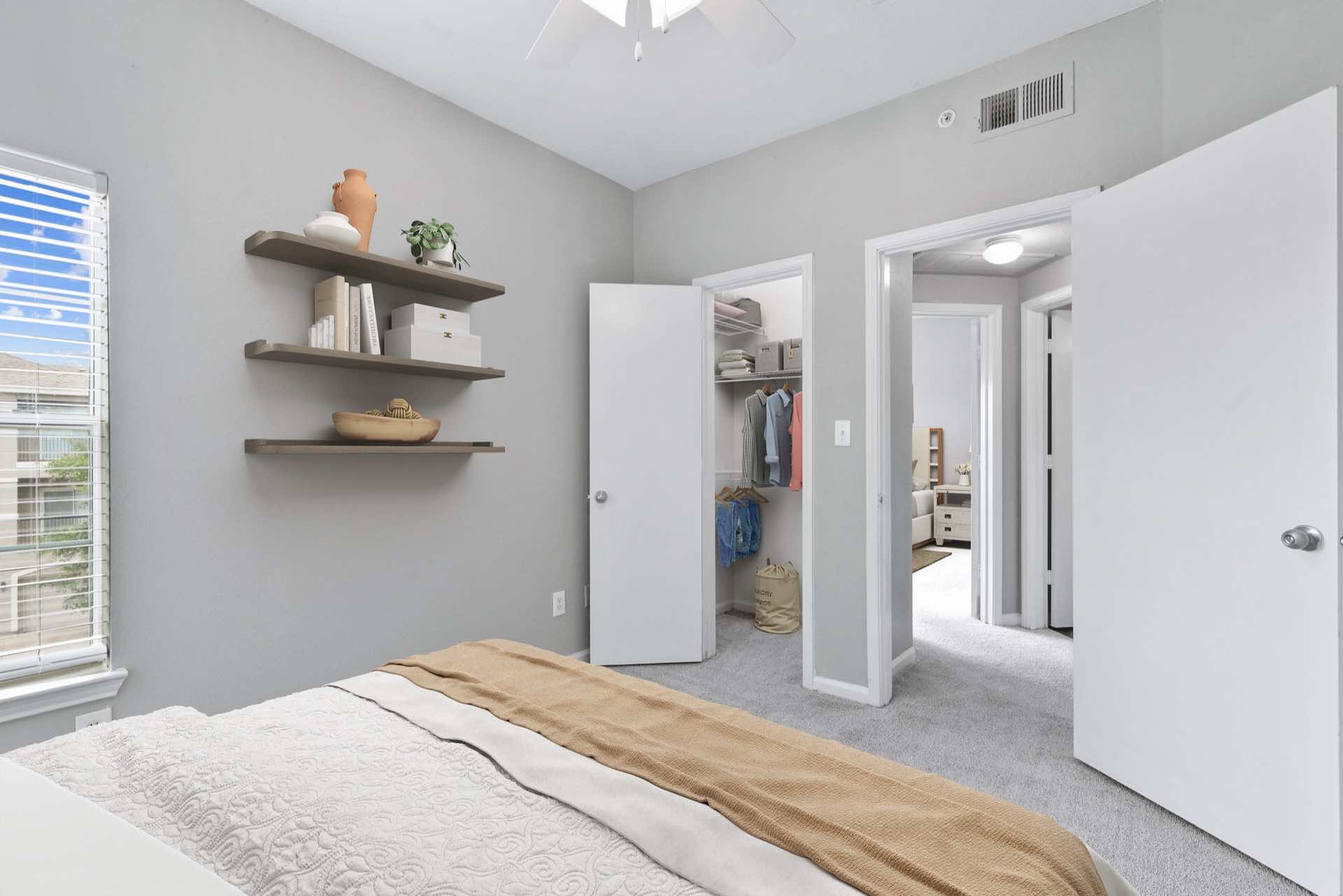 Carpeted bedroom with reach-in closet